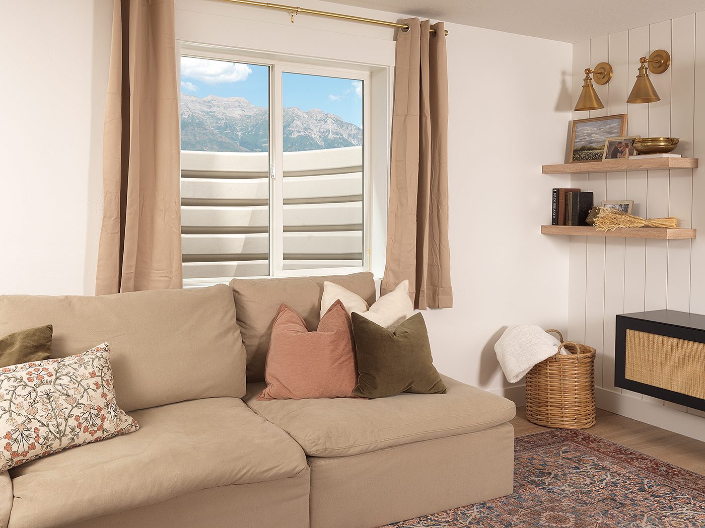 The same basement family room window looking out at a smooth, light gray ribbed Denali window well