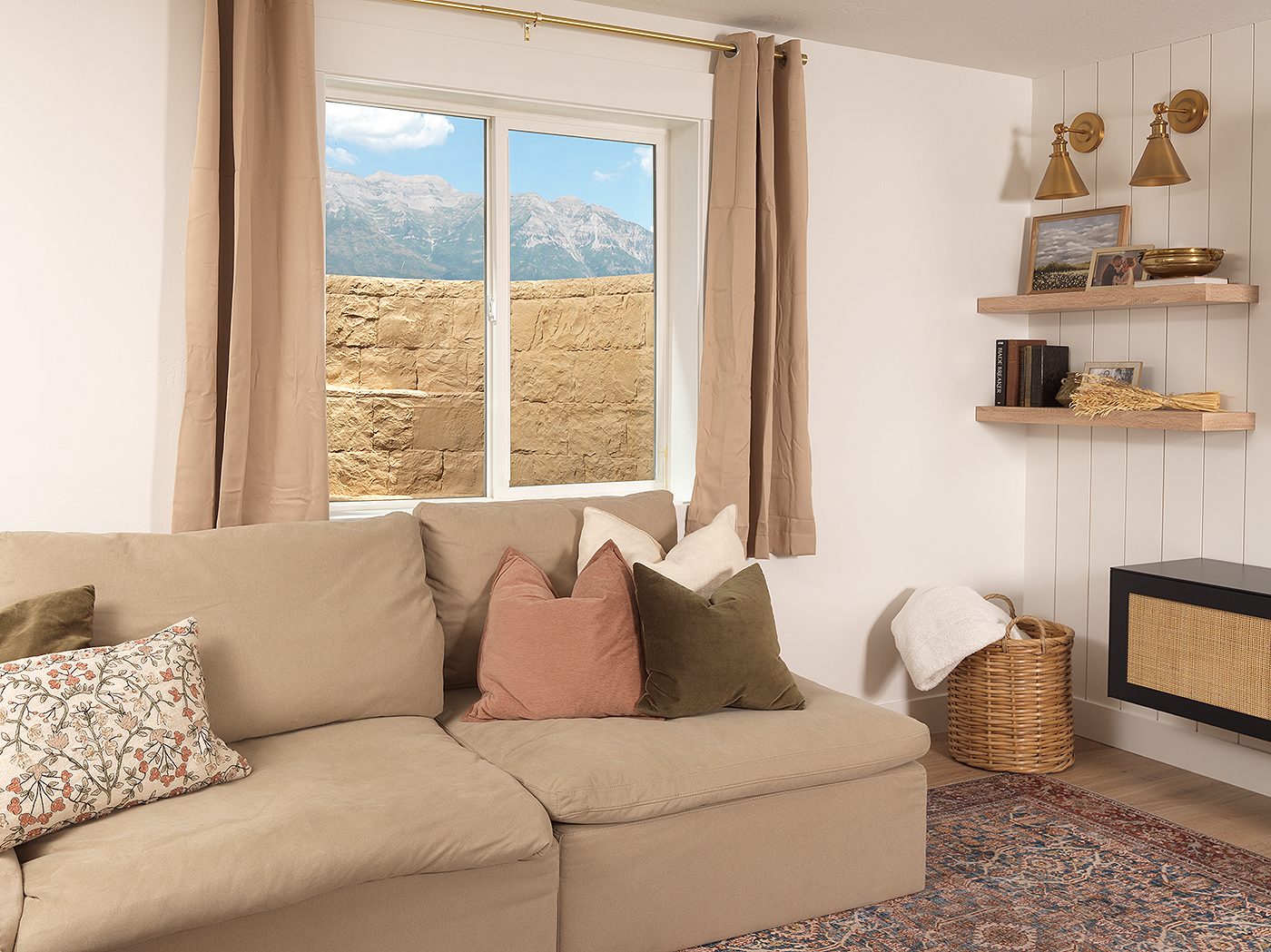 Basement family room window looking out at a tan stone-textured RockWell window well